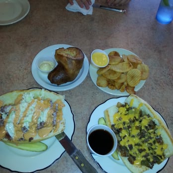 Dolsie's Lunch Box Grille - On the left is the pastrami sandwich and on the right is the Philly cheesesteak OMG top left is the amazing pop over and fries - New American Near Me - Saint Cloud, Minnesota Dolsie's Lunch Box Grille - On the left is the pastrami sandwich and on the right is the Philly cheesesteak OMG top left is the amazing pop over and fries - New American Near Me - Saint Cloud, Minnesota