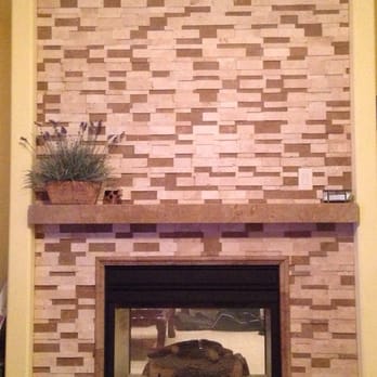 Italian Heritage Tile & Stone - Family room fireplace with Ivory/Noce Honed 3D Stack Stone and Noce Travertine mantle and matching hearth. - General Contractors Near Me Italian Heritage Tile & Stone - Family room fireplace with Ivory/Noce Honed 3D Stack Stone and Noce Travertine mantle and matching hearth. - General Contractors Near Me