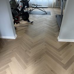 Renova - Finished herringbone flooring project with professional installation and attention to detail.