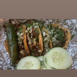 Al pastor and asada tacos with fixings. Al pastor and asada tacos with fixings.