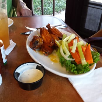 The Grill At Stonegate - Spicy chicken wings with carrots and celery and ranch dressing - New American Near Me - Kissimmee, Florida The Grill At Stonegate - Spicy chicken wings with carrots and celery and ranch dressing - New American Near Me - Kissimmee, Florida