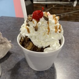 an ice cream sundae with whipped cream and a strawberry