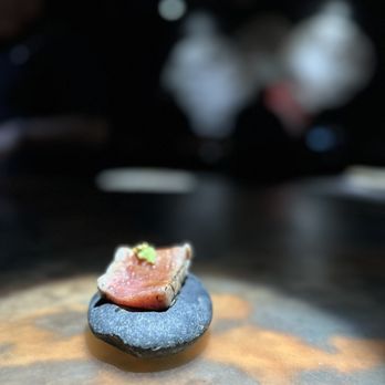 Nossa Omakase - a piece of salmon on a rock - Japanese Near Me - Miami Beach, Florida Nossa Omakase - a piece of salmon on a rock - Japanese Near Me - Miami Beach, Florida