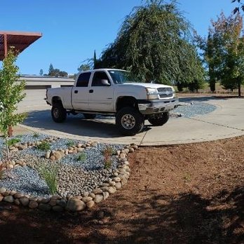 Guzman Landscaping - a white truck parked in a driveway - Landscaping Near Me
