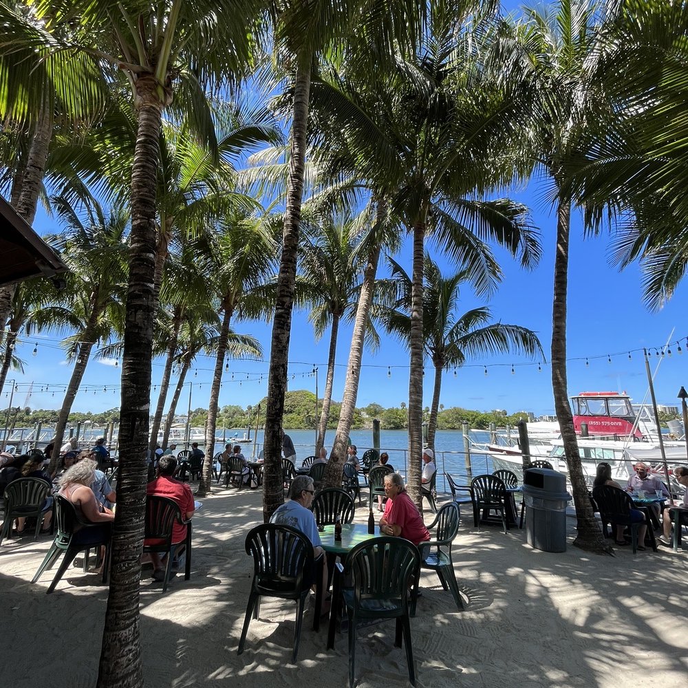 Square Grouper Tiki Bar - people sitting at tables on the beach - Tiki Bars Near Me - Jupiter, Florida Square Grouper Tiki Bar - people sitting at tables on the beach - Tiki Bars Near Me - Jupiter, Florida