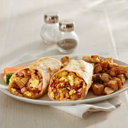 Sunset Grill - Peameal-style bacon, ham, bacon, sausage, home fries, sautéed onion, eggs and cheddar cheese.