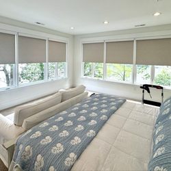 Delmarva Blinds and Shutters - Motorized Room darkening roller shades in the color Fawn.