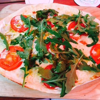 RheinZeit - Flammkuchen with tomatoes, mozzarella, and rocket. - Mediterranean Near Me - Cologne, NW RheinZeit - Flammkuchen with tomatoes, mozzarella, and rocket. - Mediterranean Near Me - Cologne, NW