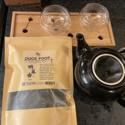 a black tea pot and two glasses a black tea pot and two glasses