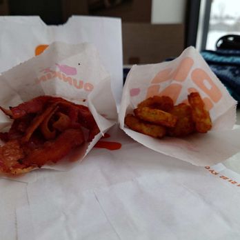 Dunkin - two pieces of bacon wrapped in paper on a table - Coffee & Tea Near Me - Algonquin, Illinois Dunkin - two pieces of bacon wrapped in paper on a table - Coffee & Tea Near Me - Algonquin, Illinois