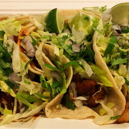 2 carnitas tacos on the left and 1 al pastor on the right