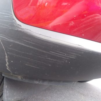 Midas - Scratches ..you can see the scratch on the Grey part of the bumper and you will also see yellow scratches on the red paint - Oil Change Stations Near Me - Syracuse, New York