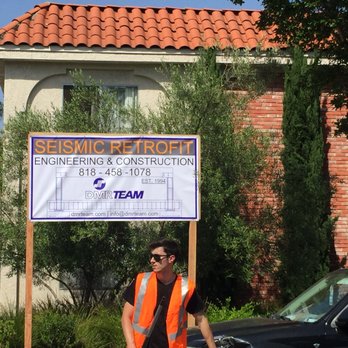 DMR Team - a man in an orange vest standing in front of a sign - Structural Engineers Near Me - Chatsworth, California