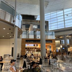 It is located on the Mezzanine level, up the escalator/elevator above other shops and restaurants in terminal D
