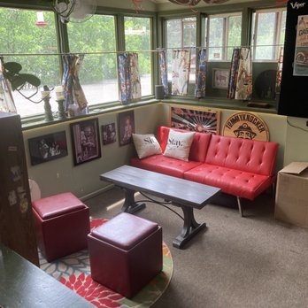 Sit N Bull Saloon - a red couch and a coffee table - American Near Me - Indian Hills, Colorado