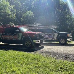Merrimack Valley Roofing & Gutter - Merrimack Valley Roofing Trucks at a residential roofing jobsite