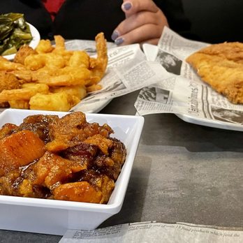 Fish N' Grill -  person sitting at a table with plates of food - Seafood Near Me - Fredericksburg, Virginia