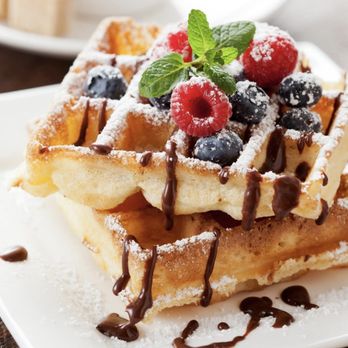 Funny Mugs Bistro - Home made Belgian Waffles topped with strawberry and blueberry and chocolate syrup. - Breakfast & Brunch Near Me - Port Richey, Florida Funny Mugs Bistro - Home made Belgian Waffles topped with strawberry and blueberry and chocolate syrup. - Breakfast & Brunch Near Me - Port Richey, Florida