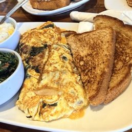 Omelette with cheddar, Delia's sausage (IYKYK), spinach, and onions with corn grits and wheat toast Omelette with cheddar, Delia's sausage (IYKYK), spinach, and onions with corn grits and wheat toast