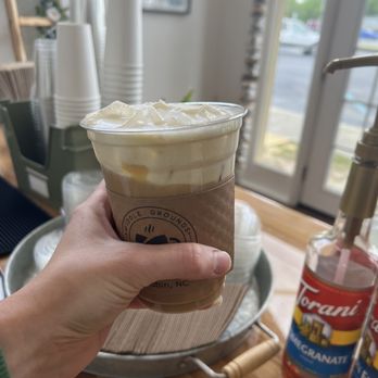 Middle Grounds - Drive Thru - a hand holding a cup of iced coffee - Coffee & Tea Near Me - Kinston, North Carolina Middle Grounds - Drive Thru - a hand holding a cup of iced coffee - Coffee & Tea Near Me - Kinston, North Carolina
