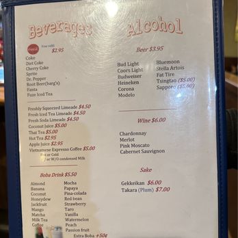 Pho Duy - A menu features sections for beverages, alcohol, wine, and sake, with prices listed for each item. Beverages include sodas, teas, coconut juice, and coffee, while alcohol options include beers like Bud Light and Heineken, and wines such as Chardonnay and Merlot. Sake options are Gekkeikan and Takara Plum. Prices range from $2.95 to $7.00, with some items marked with special prices. The menu is printed on a light background with red and black text. - Vietnamese Near Me - Greeley, Colorado