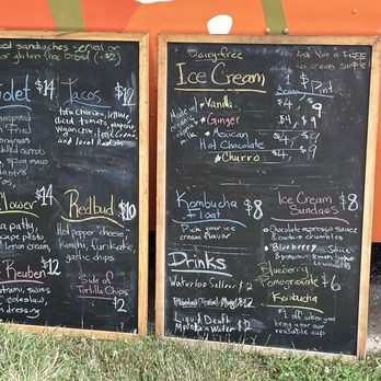 Planted Bloomington - Zoom in to see all the different options, flavors, ingredients. Flavorful choices even if not vegetarian. - Two blackboards list menu options, prices, and descriptions for ice cream, drinks, and food items outside a business. - Vegan Near Me