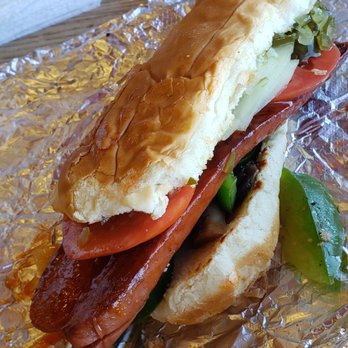 Five Guys - A good attempt for the chain but the bun is trash and cheap - A kosher hot dog in a bun topped with tomato slices, lettuce, and pickles, served on aluminum foil. - Burgers Near Me - Peoria, Illinois