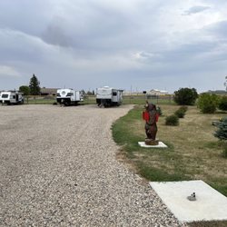 Tioga RV & Trailer Park - Bear statue has registration forms and payment slot. Dump site is shown In foreground. Dump fee $10