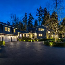 Hardscape lighting to highlight bushes in driveway.