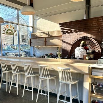 Cafe Olli - Not a lot of tables inside but there is this wide counter as you walk in the door, with the brick oven in background. - Cafes Near Me - Portland, Oregon Cafe Olli - Not a lot of tables inside but there is this wide counter as you walk in the door, with the brick oven in background. - Cafes Near Me - Portland, Oregon
