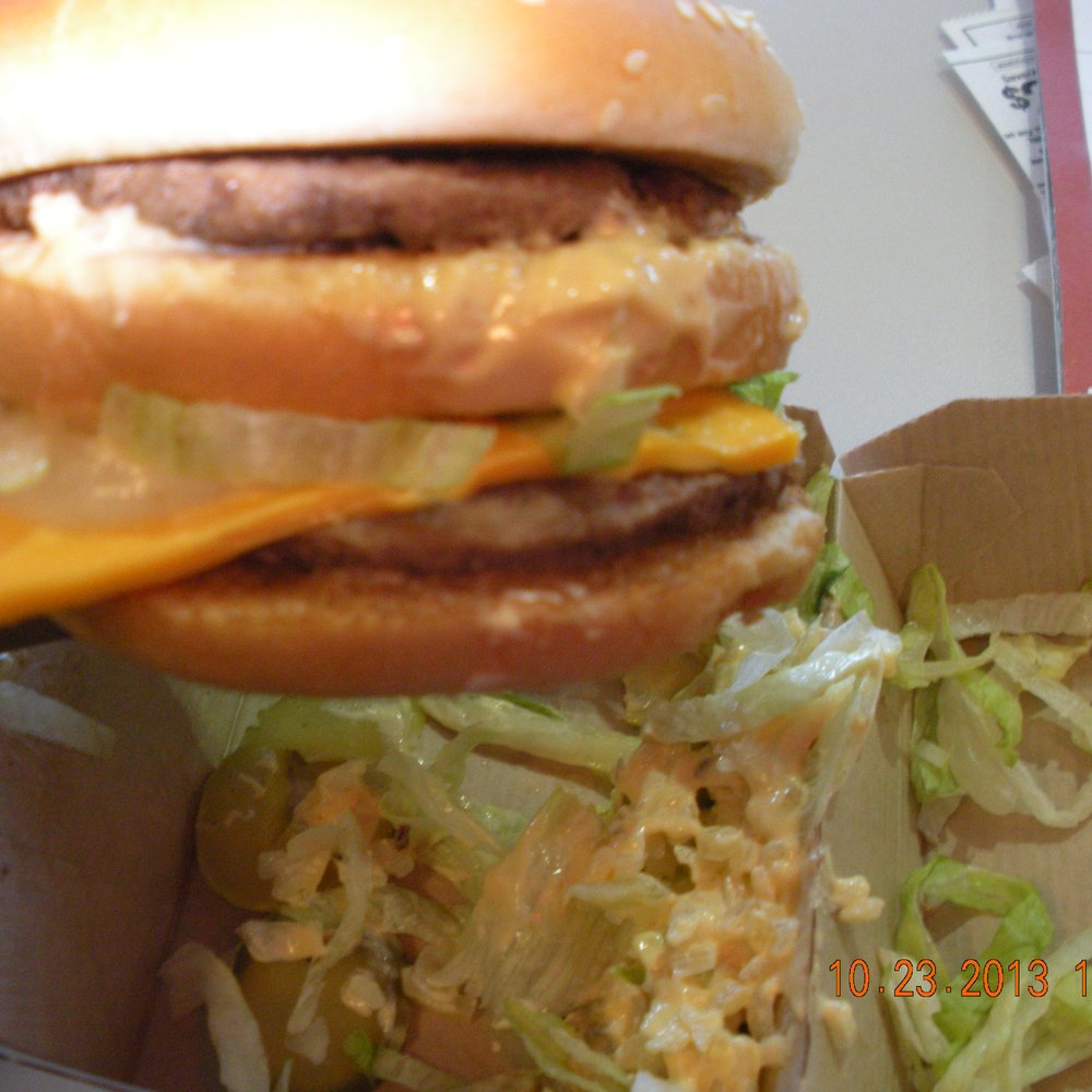 McDonald's - a hand holding a cheeseburger - Burgers Near Me - Jackson, Tennessee