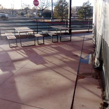 Klean It Up Services - a parking lot with tables and benches - Landscaping Near Me
