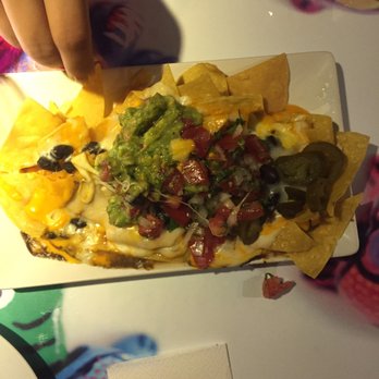 La Adelita - Nachos- 3 cheeses, black beans, guacamole, pico de gallo, and jalapeños. Enough toppings and cheese for all the nachos - Mexican Near Me - Barcelona, B La Adelita - Nachos- 3 cheeses, black beans, guacamole, pico de gallo, and jalapeños. Enough toppings and cheese for all the nachos - Mexican Near Me - Barcelona, B