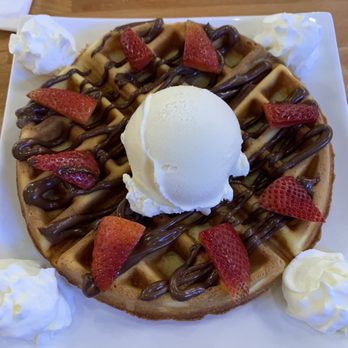 Proper Rose Garden - Waffle with Nutella drizzle topped with vanilla ice cream and strawberry. - Themed Cafes Near Me - Katy, Texas