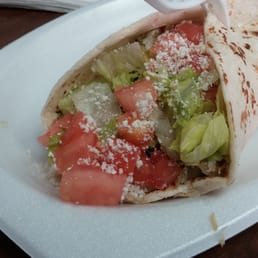 a tortilla with tomatoes and lettuce a tortilla with tomatoes and lettuce