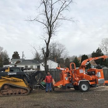 Fernando Landscaping - a man standing next to a tractor and a bulldozer - Landscaping Near Me - Alexandria, Virginia Fernando Landscaping - a man standing next to a tractor and a bulldozer - Landscaping Near Me - Alexandria, Virginia
