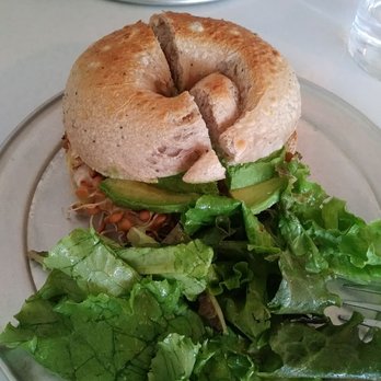 Community Loaves - White bean hummus with Avacado on everything bagel with side salad - Bakeries Near Me - Jacksonville, Florida Community Loaves - White bean hummus with Avacado on everything bagel with side salad - Bakeries Near Me - Jacksonville, Florida