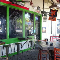 The Glass Turtle - The front door is located on the deck of the restaurant, and you'll note the sports pennants and beer signs, along with the state flag.
