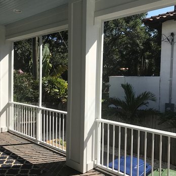 Restoring Florida Homes - a covered porch with a table and chairs - General Contractors Near Me - Tampa, Florida Restoring Florida Homes - a covered porch with a table and chairs - General Contractors Near Me - Tampa, Florida