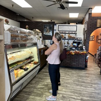 Everything Bagel - a woman standing in a bakery - Bagels Near Me - St. Augustine, Florida Everything Bagel - a woman standing in a bakery - Bagels Near Me - St. Augustine, Florida