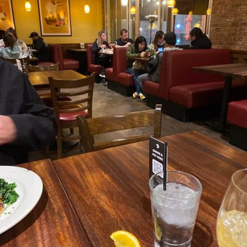 Tomatina - a man sitting at a table in a restaurant - Italian Near Me - San Jose, California Tomatina - a man sitting at a table in a restaurant - Italian Near Me - San Jose, California