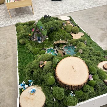 Create Studio ATX - A detailed miniature landscape features trees, ponds, a small house, and bridges, set on a raised platform in an indoor space. - Art Supplies Near Me - Austin, Texas