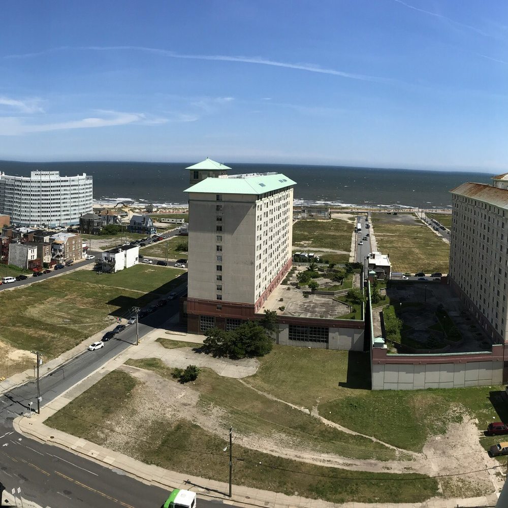 Absecon Lighthouse - View from top of Absecon Lighthouse looking out door to the left at apt bldg & Atlantic Ocean - Landmarks & Historical Buildings Near Me - Atlantic City, New Jersey
