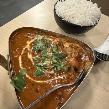 Hyderabad Cafe - a curry dish and rice on a table - Indian Near Me - Orlando, Florida Hyderabad Cafe - a curry dish and rice on a table - Indian Near Me - Orlando, Florida