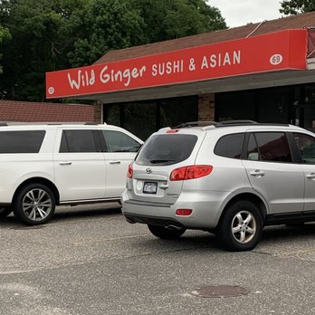 Wild Ginger - two cars parked in front of a restaurant - Asian Fusion Near Me - Smithtown, New York