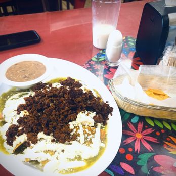 Taquería Doña Raquél - Green chilaquiles with Mexican sausage and refried beans. - Mexican Near Me - Pompano Beach, Florida Taquería Doña Raquél - Green chilaquiles with Mexican sausage and refried beans. - Mexican Near Me - Pompano Beach, Florida