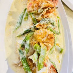 Salute Ristorante - Veal and shrimp Monte Carlo egg butter  sautéed with fresh asparagus with brandy cream sauce  top with jumbo crab meat and mozzarella cheese