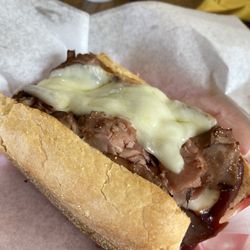 Jon's Roast Beef & Deli - Half of large roast beef with bbq sauce, provolone cheese and horseradish sauce. Served with pickle spear and chips.