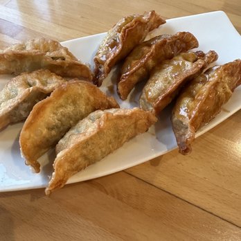 Bonchon Bolingbrook - Pork Potstickers half with sauce. Definitely get with the sauce. - Korean Near Me - Bolingbrook, Illinois