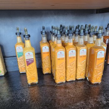 Nando's Peri-Peri - A suite of peri-peri sauce (from mild to v. hot w. with flavors sprinkled in between). - South African Near Me - Houston, Texas Nando's Peri-Peri - A suite of peri-peri sauce (from mild to v. hot w. with flavors sprinkled in between). - South African Near Me - Houston, Texas